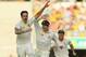 BRISBANE, AUSTRALIA - NOVEMBER 23: Mitchell Johnson of Australia celebrates with team mates Steve Smith (L) and David Warner after dismissing Jonathan Trott of England during day three of the First Ashes Test match between Australia and England at The Ga