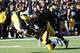 Nov 23, 2013; Iowa City, IA, USA; Michigan Wolverines tight end Devin Funchess (87) is tackled by Iowa Hawkeyes cornerback Desmond King (14) and linebacker Anthony Hitchens (31) at Kinnick Stadium. Iowa beat Michigan 24-21. Mandatory Credit: Reese Strick
