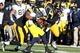 Nov 23, 2013; Iowa City, IA, USA; Michigan Wolverines quarterback Devin Gardner (98) is sacked by Iowa Hawkeyes linebacker Christian Kirksey (20) and left tackle Carl Davis (71) at Kinnick Stadium. Iowa beat Michigan 24-21. Mandatory Credit: Reese Strick