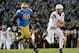 PASADENA, CA - NOVEMBER 23: Taylor Kelly #10 of the Arizona State Sun Devils scrambles in the pocket away from Ellis McCarthy #90 of the UCLA Bruins during the second quarter at Rose Bowl on November 23, 2013 in Pasadena, California. (Photo by Harry How