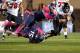 TOLEDO, OH - NOVEMBER 20: Jordan Lynch #6 of the Northern Illinois Huskies is tackled by Jayrone Elliott #15 and Christian Smith #9 of the Toledo Rockets during the fourth quarter on November 20, 2013 at the Glass Bowl in Toledo, Ohio. Northern Illinois