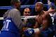 LAS VEGAS, NV - SEPTEMBER 14: Trainer/father Floyd Mayweather Sr. talks with his son Floyd Mayweather Jr. between rounds against Canelo Alvarez during their WBC/WBA 154-pound title fight at the MGM Grand Garden Arena on September 14, 2013 in Las Vegas, N