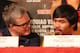 BEVERLY HILLS, CA - AUGUST 08: Manny Pacquiao speaks with trainer Freddie Roach at a press conference previewing the upcoming match against Brandon Rios at Beverly Hills Hotel on August 8, 2013 in Beverly Hills, California. (Photo by Stephen Dunn/Gett