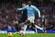 MANCHESTER, ENGLAND - NOVEMBER 24: Yaya Toure of Manchester City breaks past Kyle Walker of Tottenham Hotspur on the way to setting up Sergio Aguero for their team's fourth goal during the Barclays Premier League match between Manchester City and Tottenha