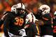 STILLWATER, OK - NOVEMBER 23: Emmanuel Ogbah #38 of the Oklahoma State Cowboys celebrates with teammates in the second quarter against the Baylor Bears at Boone Pickens Stadium on November 23, 2013 in Stillwater, Oklahoma. (Photo by Ronald Martinez/Gett