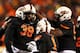 STILLWATER, OK - NOVEMBER 23: Emmanuel Ogbah #38 of the Oklahoma State Cowboys celebrates with teammates in the second quarter against the Baylor Bears at Boone Pickens Stadium on November 23, 2013 in Stillwater, Oklahoma. (Photo by Ronald Martinez/Gett