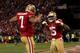 SAN FRANCISCO, CA - JANUARY 12: Quarterback Colin Kaepernick #7 of the San Francisco 49ers celebrates with wide receiver Michael Crabtree #15 after running the ball for a touchdown against the Green Bay Packers in the third quarter during the NFC Divisio