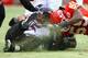Belcher collides with Ravens quarterback Joe Flacco in a playoff game during the 2010 season.