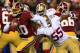 LANDOVER, MD - NOVEMBER 25: Quarterback Robert Griffin III #10 of the Washington Redskins runs the ball as outside linebacker Ahmad Brooks #55 of the San Francisco 49ers rushes in in the first quarter at FedExField on November 25, 2013 in Landover, Maryl