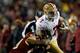 LANDOVER, MD - NOVEMBER 25: Colin Kaepernick #7 of the San Francisco 49ers is tackled by London Fletcher #59 of the Washington Redskins as he scrambles with the ball in the second half of an NFL game at FedExField on November 25, 2013 in Landover, Maryla
