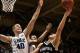Nov 18, 2013; Durham, NC, USA; Duke Blue Devils center Marshall Plumlee (40) and forward Rodney Hood (5) defend against North Carolina-Asheville Bulldogs guard David Robertson (13) at Cameron Indoor Stadium. Mandatory Credit: Mark Dolejs-USA TODAY Sports