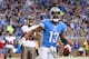 DETROIT, MI - NOVEMBER 24: Nate Burleson #13 of the Detroit Lions celebrates after scoring a touchdown on an 11 yard pass from quarterback Matthew Stafford #9 during the game against the Tampa Bay Buccaneers at Ford Field on November 24, 2013 in Detroit,
