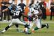 Nov 24, 2013; Miami Gardens, FL, USA; Miami Dolphins running back Lamar Miller (26) is tackled by Carolina Panthers defensive tackle Colin Cole (91) and outside linebacker Thomas Davis (58) in the second half of a game at Sun Life Stadium. The Panthers w