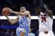 Nov 24, 2013; Uncasville, CT, USA; North Carolina Tar Heels guard Marcus Paige (5) shoots the ball around Louisville Cardinals forward Montrezl Harrell (24) during the second half at Mohegan Sun Arena. Mandatory Credit: Mark L. Baer-USA TODAY Sports