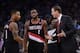 November 23, 2013; Oakland, CA, USA; Portland Trail Blazers head coach Terry Stotts (right) instructs point guard Damian Lillard (0) and shooting guard Wesley Matthews (2) against the Golden State Warriors during the second quarter at Oracle Arena. The Tr