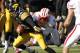 IOWA CITY, IA - NOVEMBER 2: Wide receiver Damond Powell #22 of the Iowa Hawkeyes is brought down during the third quarter by cornerback Sojourn Shelton #8 of the Wisconsin Badgers on November 2, 2013 at Kinnick Stadium in Iowa City, Iowa. Wisconsin won 2