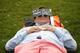 LONDON, ENGLAND - JUNE 20: A tennis fan takes a nap in the queue outside the All England Lawn Tennis and Croquet Club on Day One of the Wimbledon Lawn Tennis Championships at the All England Lawn Tennis and Croquet Club on June 20, 2011 in London, England