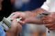 ST PETERSBURG, FL - OCTOBER 22: A fan holds tickets and another holds money before the Philadelphia Phillies take on the Tampa Bay Rays during game one of the 2008 MLB World Series on October 22, 2008 at Tropicana Field in St. Petersburg, Florida. (Phot