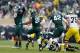 EAST LANSING, MI - NOVEMBER 02: Devin Gardner #98 of the Michigan Wolverines is sacked by Shilique Calhoun #89 of the Michigan State Spartans as teammates Micajah Reynolds #60 and Denicos Allen #28 celebrate in the first quarter at Spartan Stadium on Nov