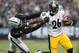 Oct 27, 2013; Oakland, CA, USA; Pittsburgh Steelers running back Le'Veon Bell (26) straight arms Oakland Raiders outside linebacker Kevin Burnett (94) during the fourth quarter at O.co Coliseum. The Oakland Raiders defeated the Pittsburgh Steelers 21-18.