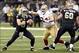 Nov 17, 2013; New Orleans, LA, USA; New Orleans Saints quarterback Drew Brees (9) scrambles out of the pocket under pressure from San Francisco 49ers defensive end Justin Smith (94) during the first quarter at Mercedes-Benz Superdome. Mandatory Credit: Jo