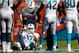 Oct 20, 2013; Miami Gardens, FL, USA; Miami Dolphins tackle Will Yeatman (72) is helped to his feet by tackle Tyson Clabo (77) in the second half of a game against the Buffalo Bills at Sun Life Stadium. Mandatory Credit: Robert Mayer-USA TODAY Sports