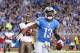 DETROIT, MI - NOVEMBER 24: Nate Burleson #13 of the Detroit Lions celebrates after scoring a touchdown on an 11 yard pass from quarterback Matthew Stafford #9 during the game against the Tampa Bay Buccaneers at Ford Field on November 24, 2013 in Detroit,