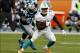 Nov 24, 2013; Miami Gardens, FL, USA; Miami Dolphins running back Lamar Miller (26) runs past Carolina Panthers outside linebacker Thomas Davis (58) in the second half of a game at Sun Life Stadium. The Panthers won 20-16. Mandatory Credit: Robert Mayer-