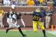 ANN ARBOR, MI - OCTOBER 05: Fitzgerald Toussaint #28 of the Michigan Wolverines runs for a first down as Derrick Wells #13 of the Minnesota Golden Gophers attempts to make the stop during the third quarter of the game at Michigan Stadium on October 5, 20