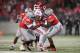 COLUMBUS, OH - NOVEMBER 23: Adolphus Washington #92 of the Ohio State Buckeyes and Noah Spence #8 of the Ohio State Buckeyes gang up to stop D'Angelo Roberts #20 of the Indiana Hoosiers at the line of scrimmage in the third quarter at Ohio Stadium on Nov