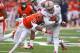 CHAMPAIGN, IL - NOVEMBER 16: Braxton Miller #5 of the Ohio State Buckeyes is hit by Zane Petty #21 of the Illinois Fighting Illini after running for a first down at Memorial Stadium on November 16, 2013 in Champaign, Illinois. (Photo by Jonathan Daniel/Ge