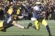 IOWA CITY, IA - NOVEMBER 23: Quarterback Devin Gardner #98 of the Michigan Wolverines breaks a tackle during the second quarter by defensive lineman Mike Hardy #98 of the Iowa Hawkeyes on November 23, 2013 at Kinnick Stadium in Iowa City, Iowa. (Photo b