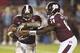 Nov 16, 2013; Starkville, MS, USA; Mississippi State Bulldogs quarterback Damian Williams (14) hands the ball off to running back LaDarius Perkins (27) during the game against the Alabama Crimson Tide at Davis Wade Stadium. Alabama Crimson Tide defeat the