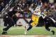 Nov 28, 2013; Baltimore, MD, USA; Pittsburgh Steelers running back Le'Veon Bell (26) runs with the ball while being pursued by Baltimore Ravens linebacker Josh Bynes (56) during a NFL football game on Thanksgiving at M&T Bank Stadium. Mandatory Credit: Ev