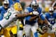 DETROIT, MI - NOVEMBER 28: Joique Bell #35 of the Detroit Lions tries to split the tackles of M.D. Jennings #43 and Tramon Williams #38 of the Green Bay Packers during a third quarter run at Ford Field on November 28, 2013 in Detroit, Michigan. (Photo by
