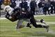 Nov 26, 2013; DeKalb, IL, USA; Western Michigan Broncos linebacker Lucas Cherocci (46) makes a catch against Northern Illinois Huskies safety Dechane Durante (1) during the second quarter at Huskie Stadium. Mandatory Credit: Mike DiNovo-USA TODAY Sports