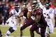 Nov 28, 2013; Starkville, MS, USA; Mississippi State Bulldogs quarterback Damian Williams (14) drops back to pass the ball during the game against the Mississippi Rebels at Davis Wade Stadium. Mandatory Credit: Spruce Derden-USA TODAY Sports