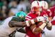 LINCOLN, NE - NOVEMBER 16: Running back Ameer Abdullah #8 of the Nebraska Cornhuskers runs through arms of defensive end Shilique Calhoun #89 of the Michigan State Spartans during their game at Memorial Stadium on November 16, 2013 in Lincoln, Nebraska. (