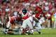 TUSCALOOSA, AL - SEPTEMBER 28: Kenyan Drake #17 of the Alabama Crimson Tide fumbles the ball as he is tackled by Woodrow Hamilton #56 of the Mississippi Rebels at Bryant-Denny Stadium on September 28, 2013 in Tuscaloosa, Alabama. (Photo by Kevin C. Cox/