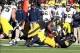 Nov 23, 2013; Iowa City, IA, USA; Michigan Wolverines quarterback Devin Gardner (98) is sacked by Iowa Hawkeyes linebacker Christian Kirksey (20) and left tackle Carl Davis (71) at Kinnick Stadium. Iowa beat Michigan 24-21. Mandatory Credit: Reese Strick