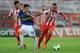 PIRAEUS, GREECE - AUGUST 25: Konstantinos Mitroglou (R) of Olympiacos FC in action against Garcia Miguel Sebastian of Atromitos FC during the greek Super League match between Olympiacos FC and Atromitos FC at Karaiskakis Stadium on August 25, 2013 in Pir