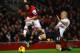 LONDON, ENGLAND - NOVEMBER 02: Martin Skrtel of Liverpool tackles Tomas Rosicky of Arsenal during the Barclays Premier League match between Arsenal and Liverpool at Emirates Stadium on November 2, 2013 in London, England. (Photo by Laurence Griffiths/Ge