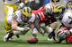 COLUMBUS, OH - NOVEMBER 24: Desmond Morgan #48 of the Michigan Wolverines and Corey Brown #3 of the Ohio State Buckeyes dive for a fumble at Ohio Stadium on November 24, 2012 in Columbus, Ohio. (Photo by Jamie Sabau/Getty Images)