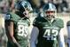 EAST LANSING, MI - NOVEMBER 30: Shilique Calhoun #89 and Denzel Drone #42 of the Michigan State Spartans look on and smile in the fourth quarter of the game against the Minnesota Golden Gophers at Spartan Stadium on November 30, 2013 in East Lansing, Mic