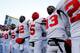 ANN ARBOR, MI - NOVEMBER 30: Quarterback Braxton Miller #5 of the Ohio State Buckeyes celebrates on the field with quarterback Kenny Guiton #13 and quarterback Cardale Jones #12 after defeating the Michigan Wolverines 42-41 in a game at Michigan Stadium