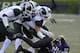 EVANSTON, IL - NOVEMBER 23: Treyvon Green #22 of the Northwestern Wildcats is tackled by Michigan State Spartans defenders during the second half on November 23, 2013 at Ryan Field in Evanston, Illinois. The Michigan State Spartans defeated the Northwest
