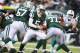 EAST RUTHERFORD, NJ - DECEMBER 01: Matt Simms #5 of the New York Jets looks to hand off the ball against the Miami Dolphins during their game at MetLife Stadium on December 1, 2013 in East Rutherford, New Jersey. (Photo by Al Bello/Getty Images)
