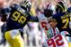 ANN ARBOR, MI - NOVEMBER 30: Quarterback Devin Gardner #98 of the Michigan Wolverines avoids a third quarter sack by defensive lineman Michael Bennett #63 of the Ohio State Buckeyes during a game at Michigan Stadium on November 30, 2013 in Ann Arbor, Mic
