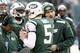 EAST RUTHERFORD, NJ - DECEMBER 1: Geno Smith #7, Matt Simms #5 and Mark Sanchez #6 of the New York Jets stand with New York Jets offensive coordinator Marty Mornhinweg during their game against the Miami Dolphins at MetLife Stadium on December 1, 2013 i