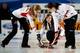 RIGA, LATVIA - MARCH 24: Rachel Homan ( C) of Canada gives instructions after she throws a stone as Lisa Weagle (R) and Alison Kreviazuk (L) sweep during the Bronze medal match between USA and Canada on Day 9 of the Titlis Glacier Mountain World Women's
